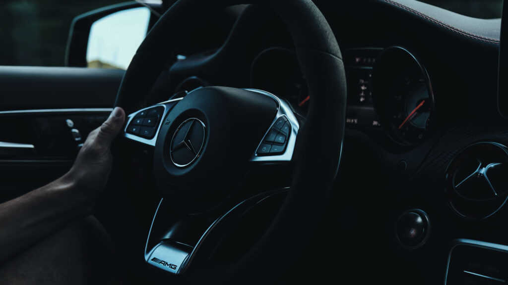 Driver behind the wheel with a clear, newly replaced windshield